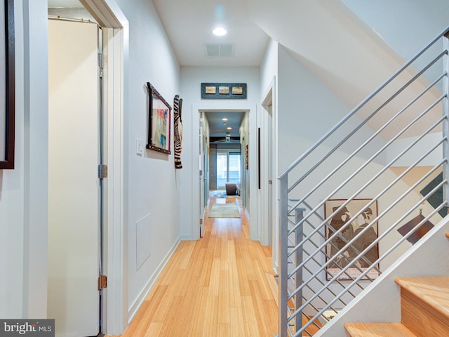 hallway with light hardwood / wood-style floors