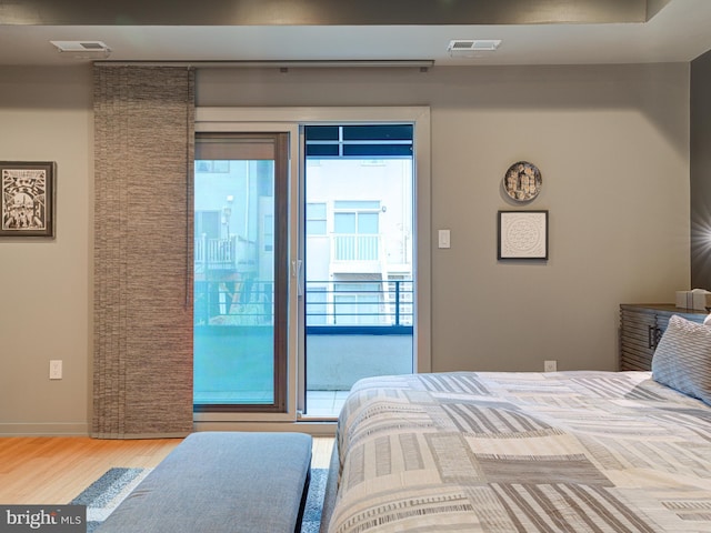 bedroom featuring hardwood / wood-style floors and access to outside