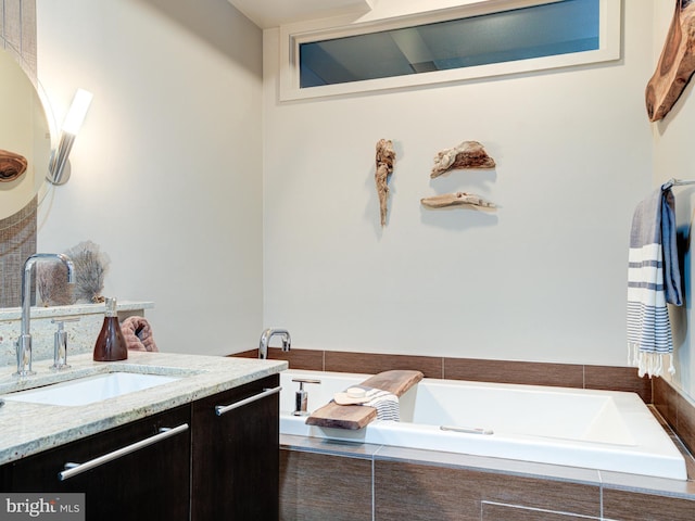 bathroom with vanity and tiled bath