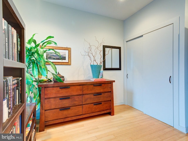 hallway with light hardwood / wood-style flooring