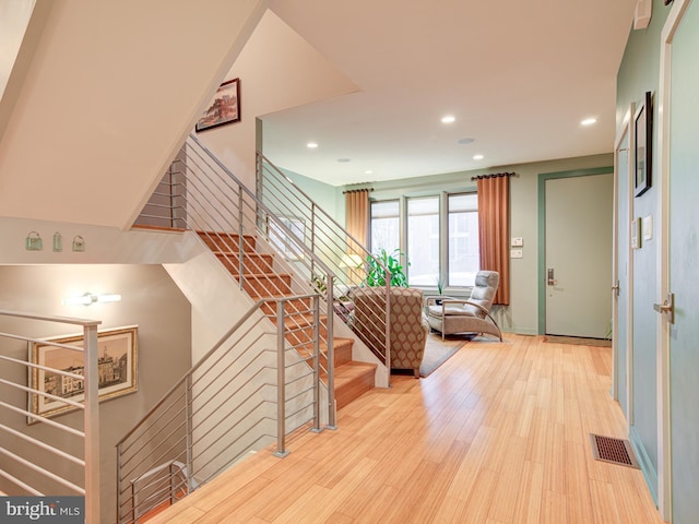 stairs with hardwood / wood-style floors