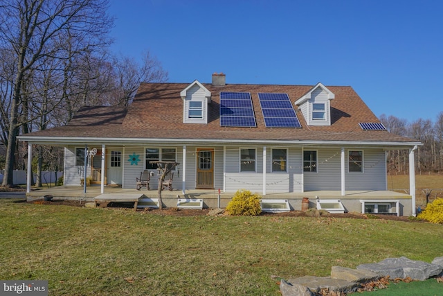 view of front of house with covered porch, a front lawn, and solar panels