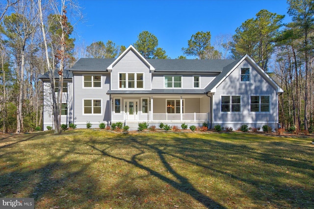 back of house with a porch and a lawn