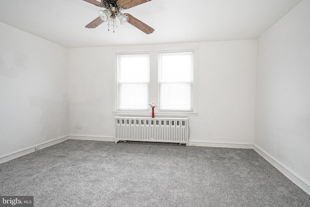 unfurnished room with radiator heating unit, ceiling fan, and carpet flooring