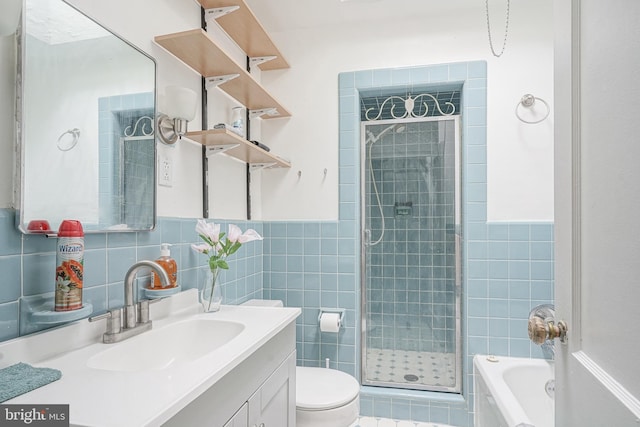 full bathroom with tile walls, vanity, independent shower and bath, and toilet