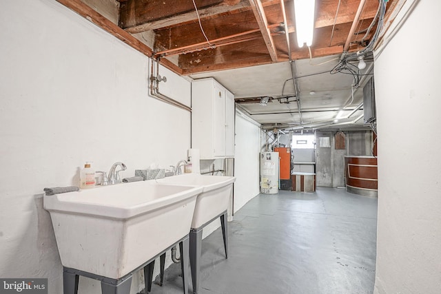 basement with gas water heater and sink