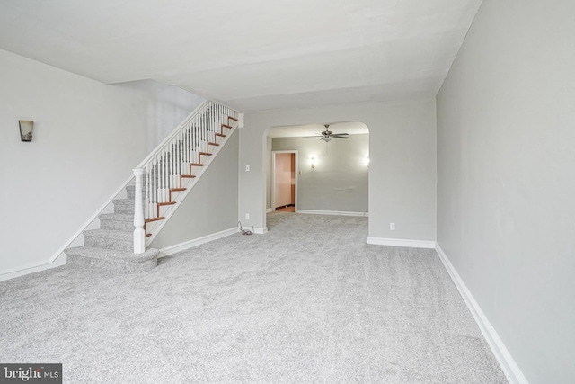 unfurnished living room with carpet floors and ceiling fan