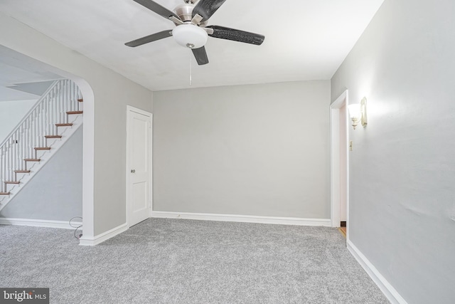 unfurnished room with ceiling fan and carpet