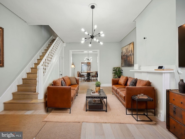 living room with light wood-type flooring and a chandelier