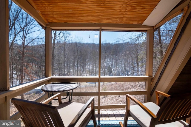 sunroom / solarium with wooden ceiling and a healthy amount of sunlight