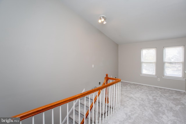 interior space featuring vaulted ceiling and carpet floors