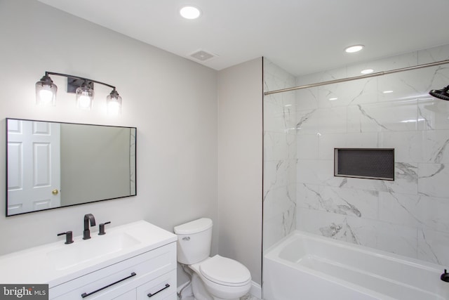 full bathroom featuring vanity, toilet, and tiled shower / bath