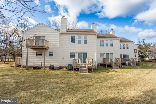 rear view of property featuring cooling unit and a lawn