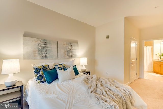 carpeted bedroom with ensuite bath