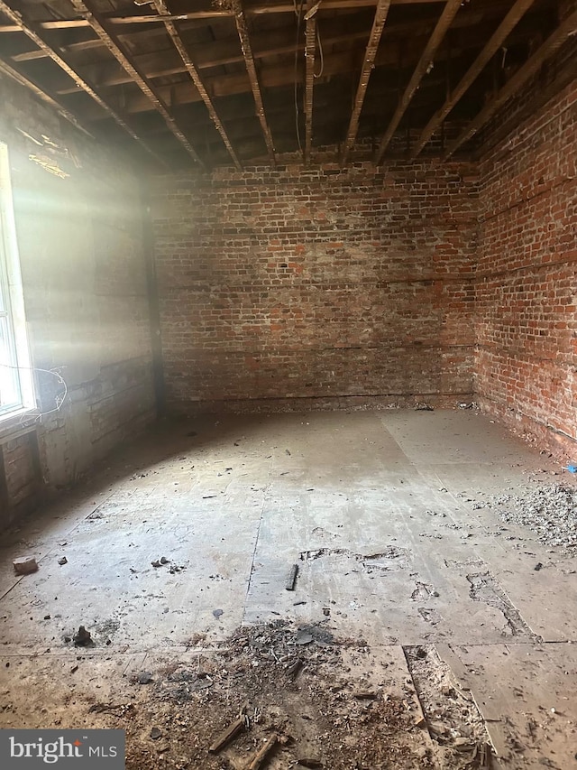 spare room with brick wall