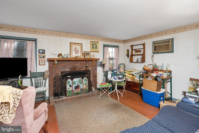 living room featuring a wall mounted air conditioner and a brick fireplace