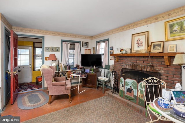 living room with a fireplace and a healthy amount of sunlight