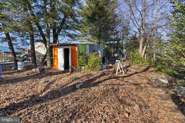 exterior space featuring a storage unit and a playground