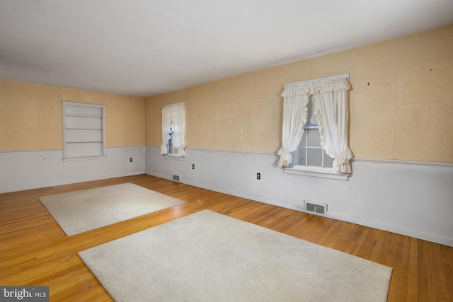 spare room with hardwood / wood-style floors