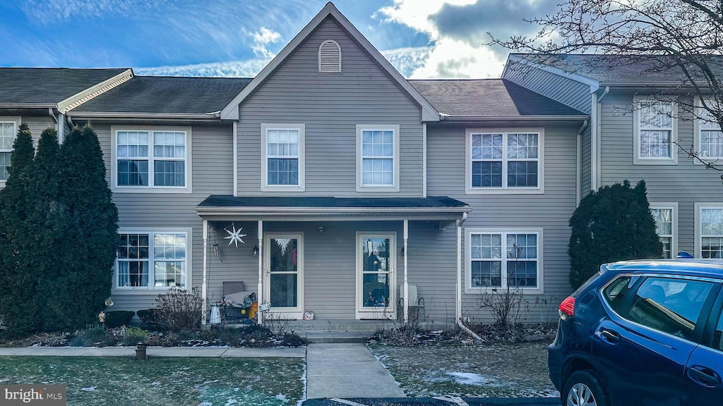 view of property featuring covered porch