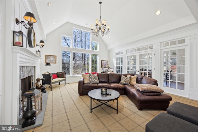 living room with a chandelier, a tiled fireplace, french doors, high vaulted ceiling, and recessed lighting