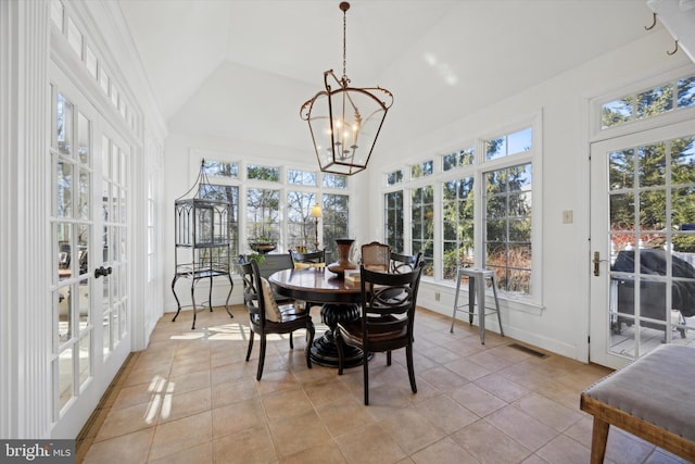 sunroom / solarium featuring an inviting chandelier, visible vents, vaulted ceiling, and french doors