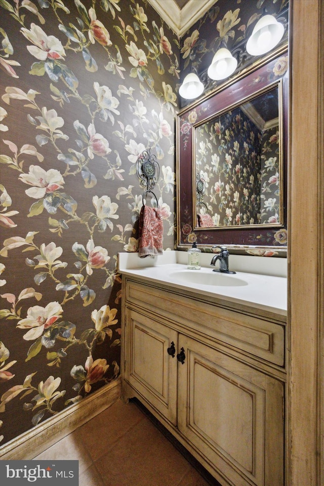 bathroom featuring wallpapered walls, vanity, baseboards, and tile patterned floors