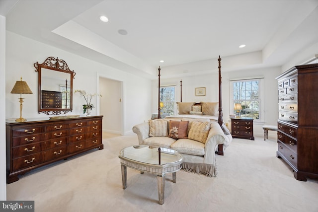 bedroom featuring a tray ceiling, light colored carpet, and recessed lighting