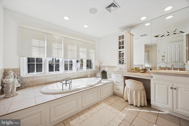 bathroom featuring a bath, vanity, visible vents, and tile patterned floors