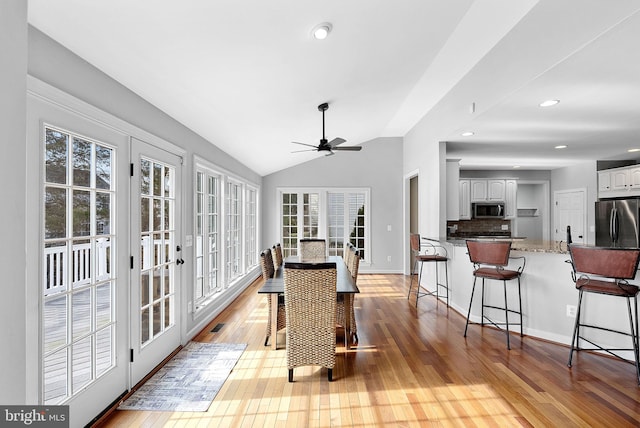 sunroom with lofted ceiling, french doors, and ceiling fan