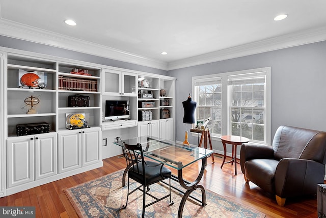 office space featuring ornamental molding and light hardwood / wood-style floors