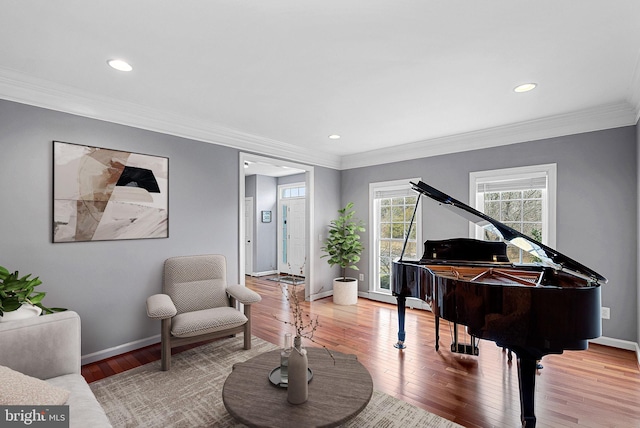 sitting room with hardwood / wood-style flooring and ornamental molding