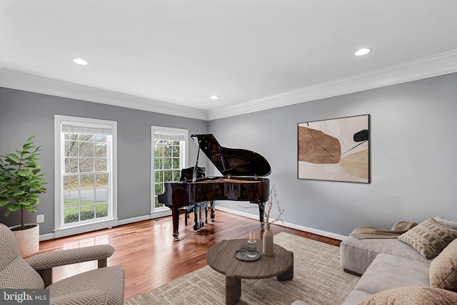 living area with crown molding and hardwood / wood-style flooring