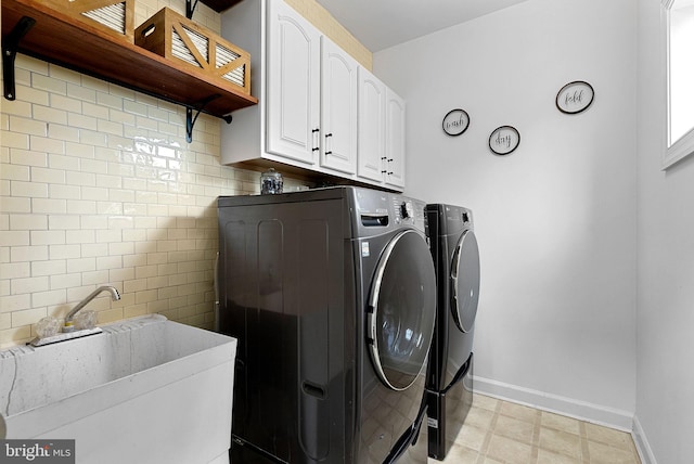 laundry room featuring sink, cabinets, and washing machine and clothes dryer