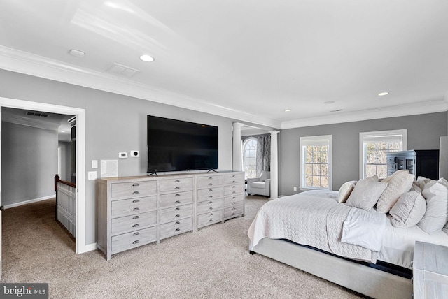 bedroom featuring decorative columns, crown molding, and light carpet