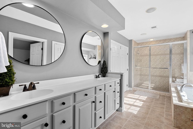 bathroom featuring vanity, tile patterned flooring, and independent shower and bath