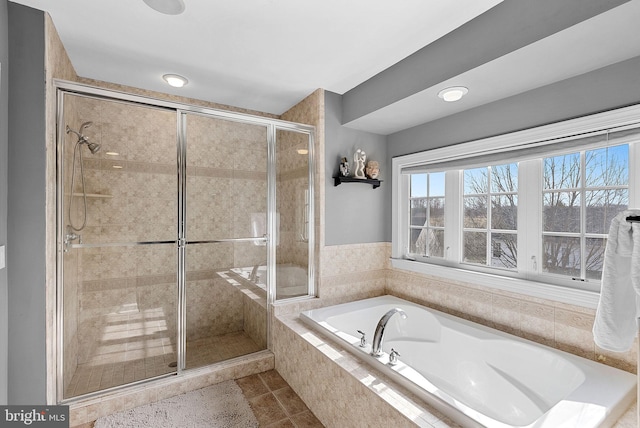 bathroom with tile patterned floors and plus walk in shower