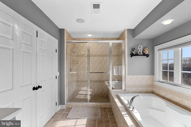 bathroom featuring tile patterned flooring and plus walk in shower