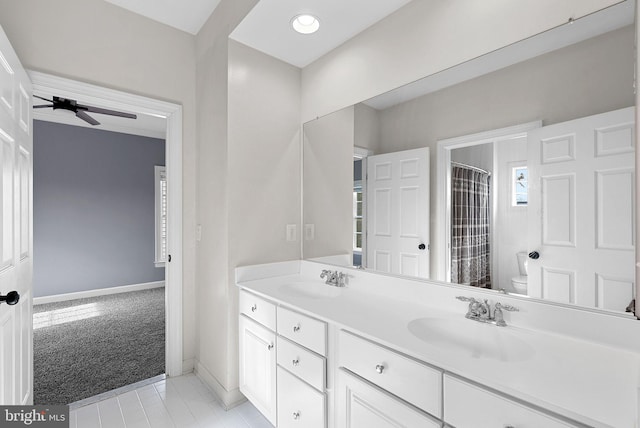 bathroom with vanity, ceiling fan, toilet, tile patterned floors, and a shower with curtain