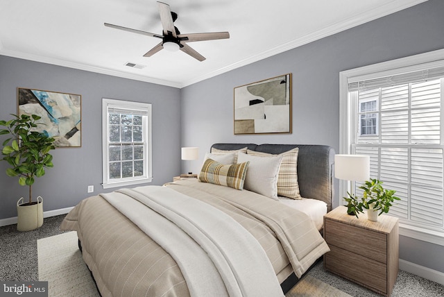 carpeted bedroom featuring crown molding and ceiling fan