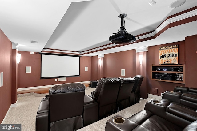 carpeted cinema with decorative columns, crown molding, and a raised ceiling