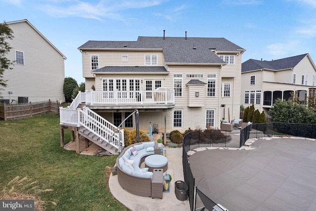 back of property with a lawn, a deck, cooling unit, a patio area, and an outdoor hangout area