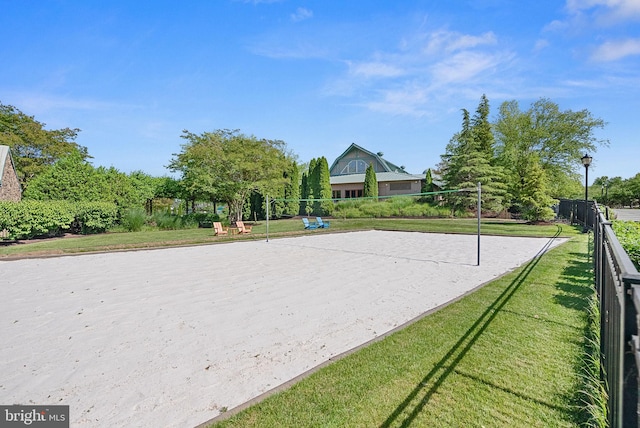 view of home's community with a lawn and volleyball court