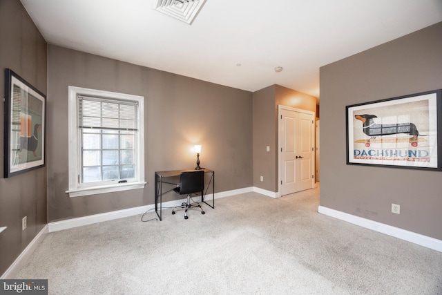 home office featuring baseboards, visible vents, and light colored carpet