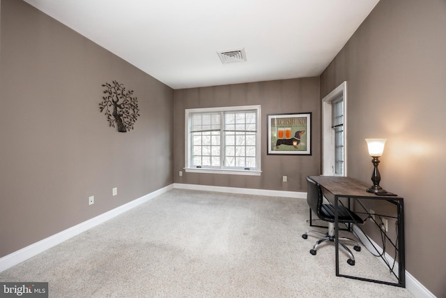 carpeted office with visible vents and baseboards