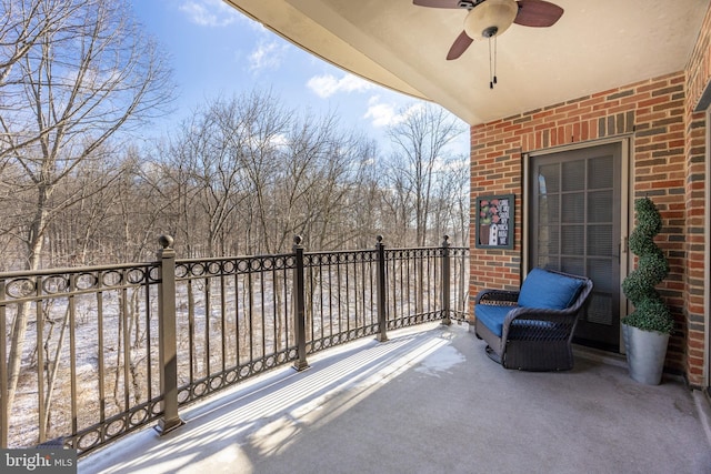 view of patio / terrace with a ceiling fan and a balcony