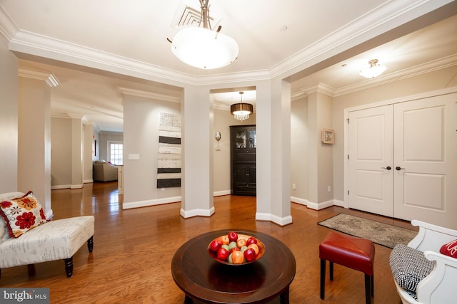 interior space featuring dark wood-type flooring, visible vents, ornamental molding, and baseboards