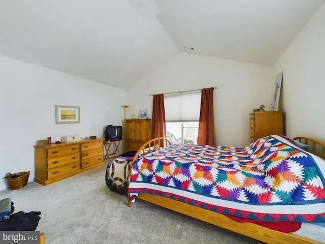 carpeted bedroom with lofted ceiling