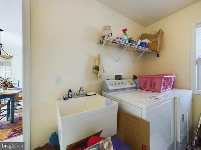 laundry area featuring a sink, laundry area, and washer and dryer