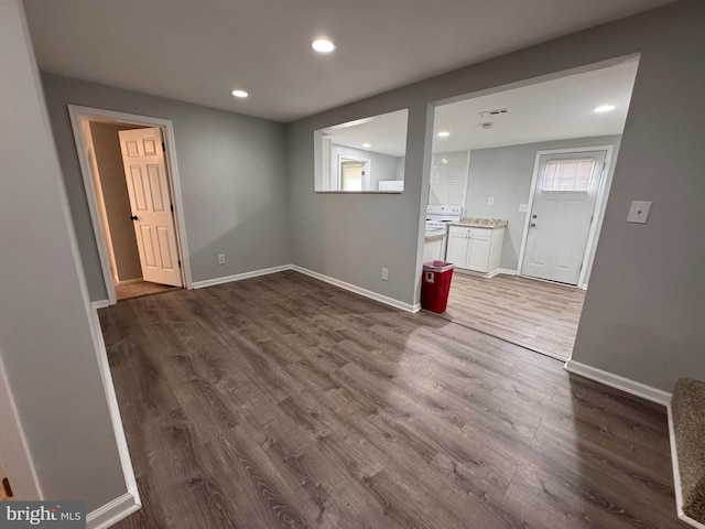 spare room with dark hardwood / wood-style floors